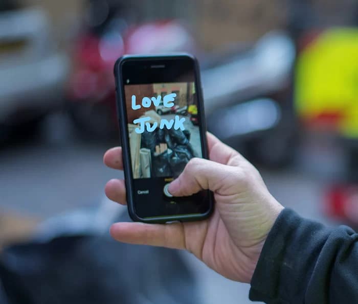 user taking photo of builder waste for removal